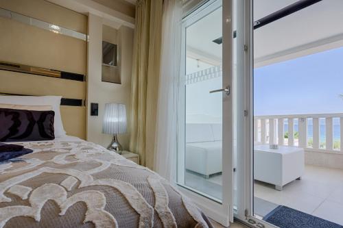 a bedroom with a bed and a large window at Damianii Luxury Boutique Hotel & Spa in Omiš