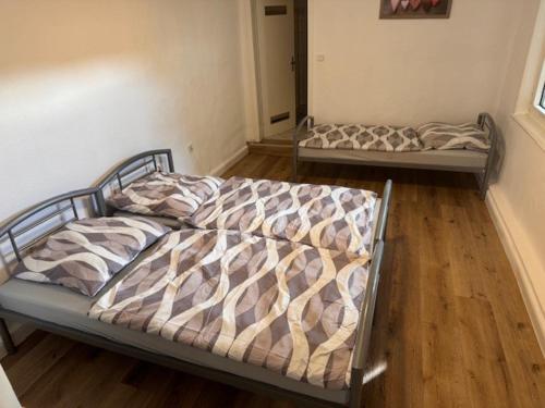 two beds in a room with wooden floors at Apartment Diez in Diez