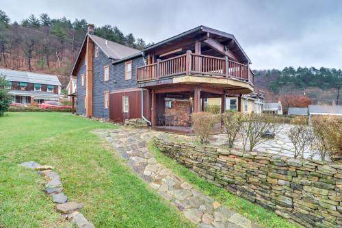 a house with a balcony on top of a stone wall at Charming and Historic Home with Lehigh River View in Parryville