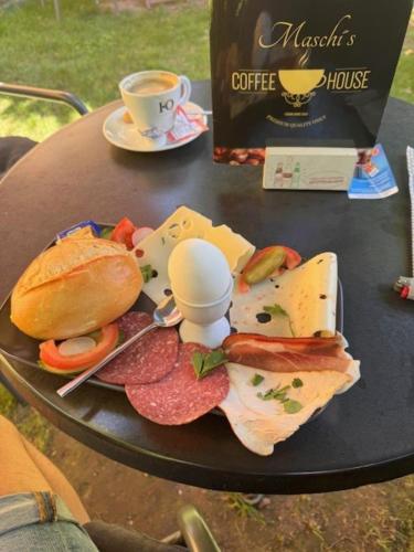 a table with a plate of food and a cup of coffee at Apartment Diez in Diez