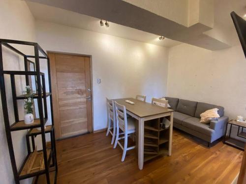 a living room with a couch and a table at Agathas Apartment - departamento céntrico in Punta Arenas