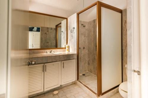 a bathroom with a sink and a shower at 3Br Penthouse Villa at Flamingos Golf in Ixtapa