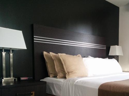 a bedroom with a large bed with a black headboard at Super 8 by Wyndham Valemount in Valemount
