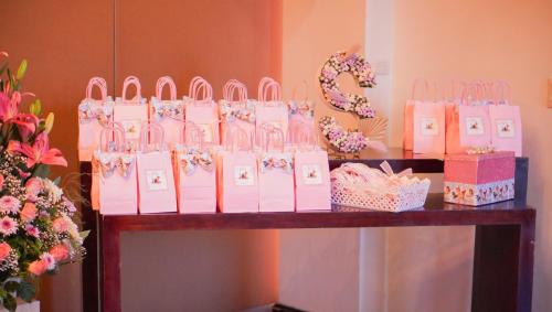 a table with pink bags and boxes on it at Hotel Colón Plaza Business Class in Nuevo Laredo