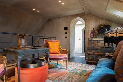a living room with a couch and a table at Cobergher Hotel in Kortrijk
