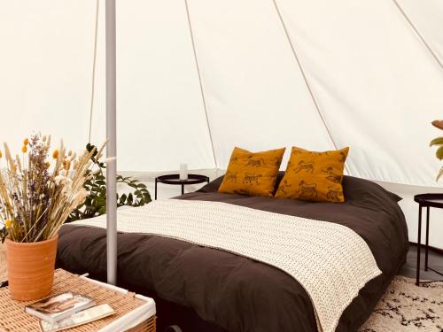 a bedroom with a bed in a tent at The Rounds in Pembrokeshire
