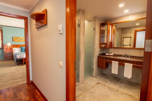 a bathroom with a sink and a mirror at Park Lake Luxury Hotel in Pucón