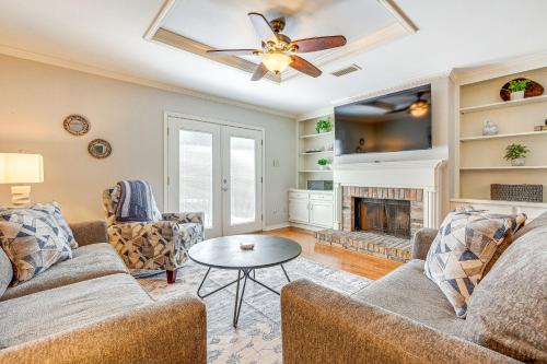 a living room with a couch and a fireplace at Mobile Townhome Near University of South Alabama! in Mobile