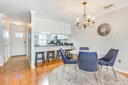 a dining room and kitchen with a table and chairs at Mobile Townhome Near University of South Alabama! in Mobile