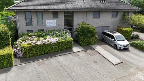 a car parked in the driveway of a house at Abalona Hotel & Apartments in Dendermonde