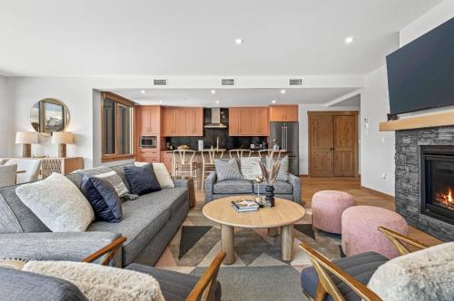 a living room with a couch and a fireplace at Rundle Lux Villa at Timberstone in Canmore
