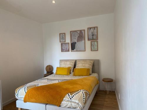 a bedroom with a bed with two yellow pillows at • Bel appartement - centre historique de Poitiers in Poitiers