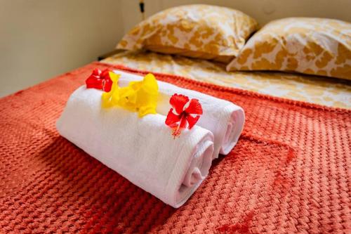 a bed with towels made to look like a house at Bungalow Rubis in Le Gosier