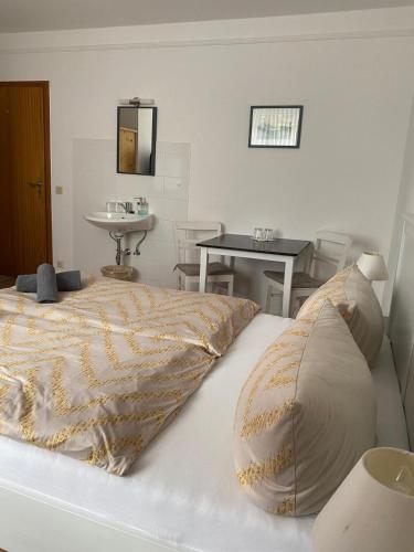 a bedroom with a bed with a sink and a mirror at Zimmer Austernfischer in Dagebüll