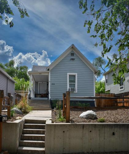 a gray house with a fence in front of it at 3 bedroom *Downtown* with Firepit in Colorado Springs