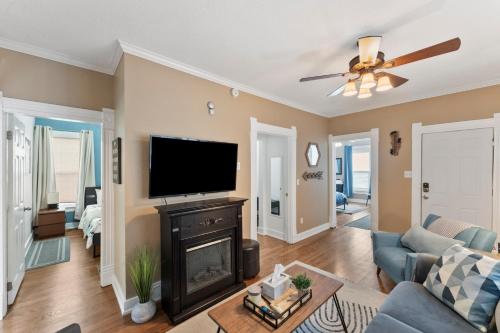 a living room with a fireplace and a flat screen tv at 3 bedroom *Downtown* with Firepit in Colorado Springs