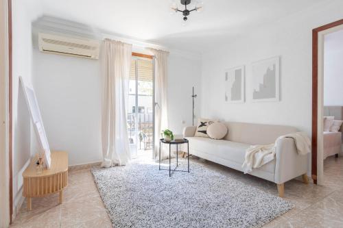 a white living room with a couch and a table at Apartamento Esperanza by Clabao in Logroño