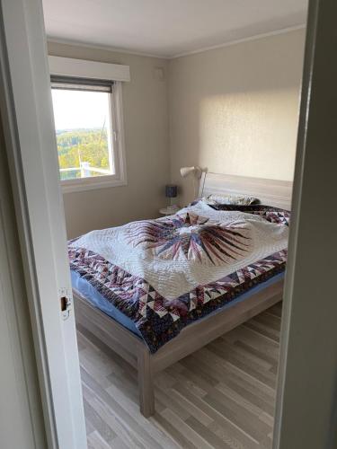 a bedroom with a bed and a window at Flott sørlandshus leies ut in Arendal