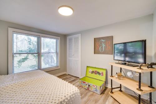 a bedroom with a bed and a flat screen tv at Walk to River and Shops Downtown Dunnellon Escape in Dunnellon
