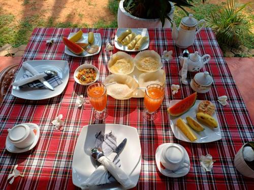 a picnic table with plates of food and drinks at Turtle Island Cabana in Tangalle