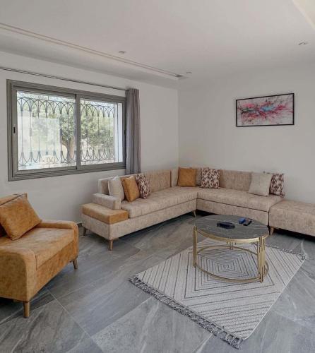 a living room with a couch and a table at Villa - Djerba in Midoun