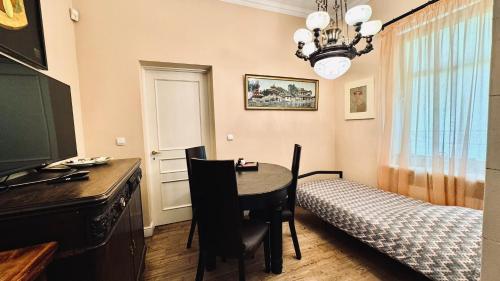 a room with a desk and a table and a bed at Villa Del Mar in Jūrmala