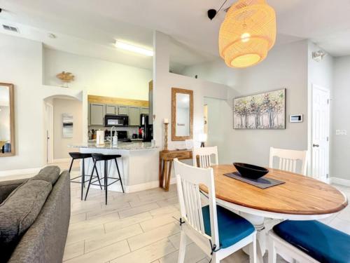 a kitchen and living room with a table and a couch at Sunshine Cove in Haines City