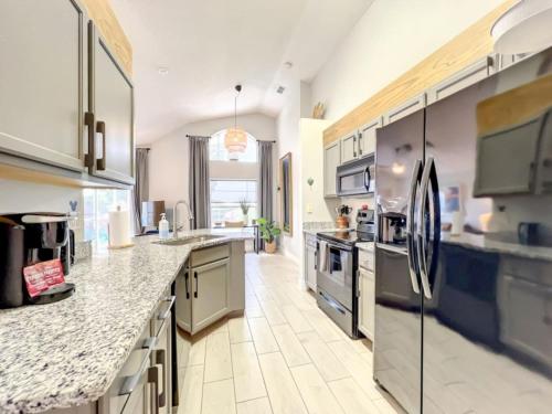 a large kitchen with granite counter tops and stainless steel appliances at Sunshine Cove in Haines City