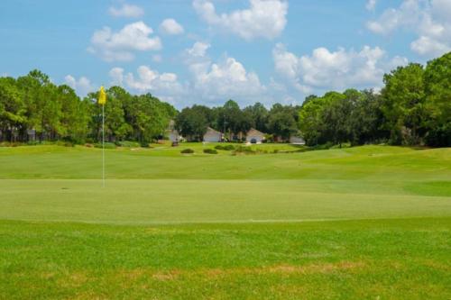 a view of a golf course with a green at Sunshine Cove in Haines City