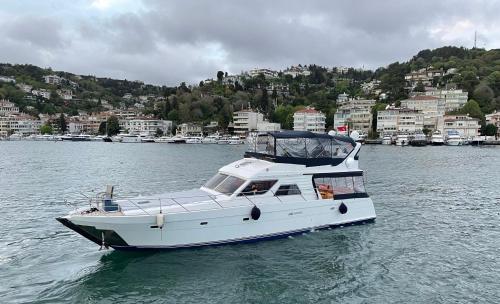 ein weißes Boot im Wasser mit einer Stadt in der Unterkunft Osman in Istanbul