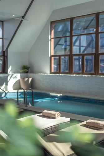 a swimming pool with two towels on the edge of it at Courtyard by Marriott Puerto Montt in Puerto Montt