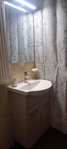 a bathroom with a sink and a mirror at Central 26 apartment in Kalamata in Kalamata