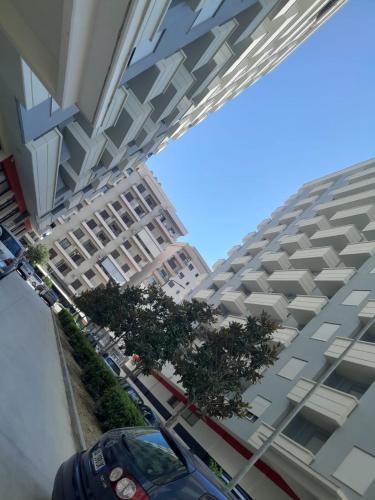 a large building with cars parked in front of it at Apartment Cela Vlore in Vlorë