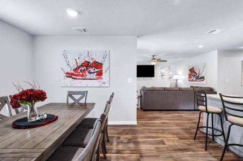 a living room with a table and chairs and a couch at The shoe LA-LA house in San Antonio