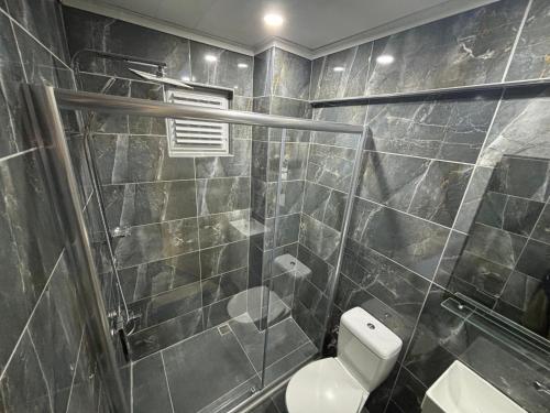 a bathroom with a toilet and a glass shower at Akapella in Pamukkale