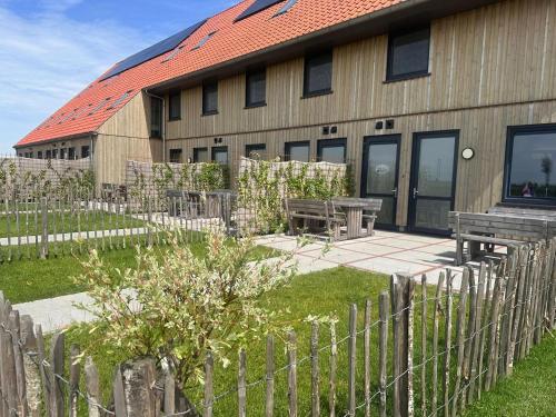 a building with a picnic table and a fence at Luxury waterfront villa in Leons