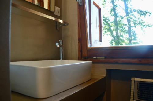 a white tub sitting on a counter next to a window at B&b Casa Rioletta in Bologna