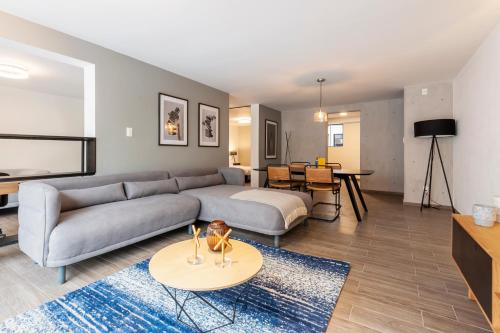 a living room with a couch and a table at Parque España 21 by Wynwood House in Mexico City