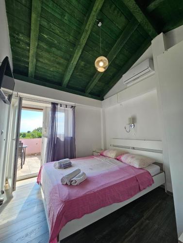 a bedroom with a bed with two towels on it at Villa Kate, with a private swimming pool and garden in Malinska