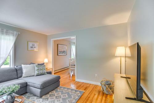 a living room with a couch and a tv at Wakefield Escape Walk to Downtown and Near Beaches! in South Kingstown