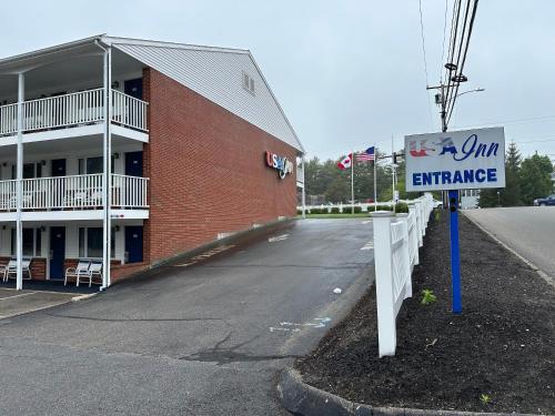 an entrance sign in front of a building at USA Inn in Wells