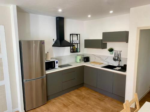 a kitchen with a stainless steel refrigerator in it at Chez Isa et Thomas in Narbonne