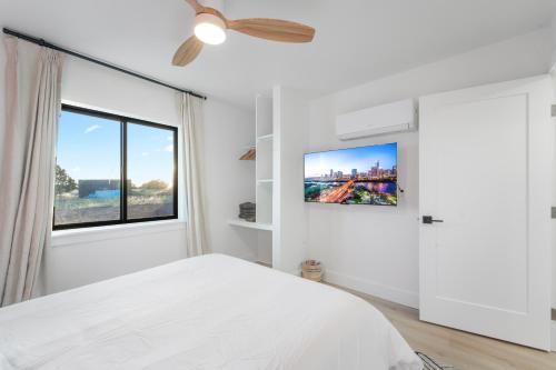 a white bedroom with a bed and a window at Luxe Desert Retreat - Near Grand Canyon South Rim in Valle
