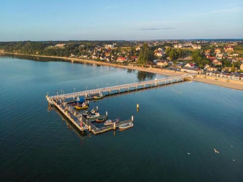 an aerial view of a dock with boats in the water at Angel Sea Hill Apartment in Mechelinki