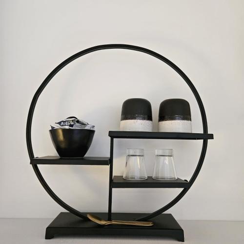 a metal shelf with two glasses and a bowl at Lazy Olives in Tongeren