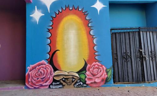 a mural on the side of a building with roses at InTown Beach front condo - Casey`s condo 1 in San Felipe