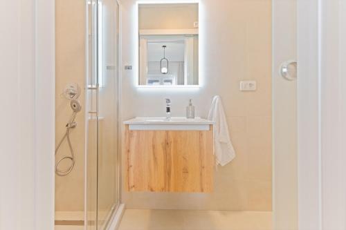 a bathroom with a sink and a shower at Lush Suites in Trogir