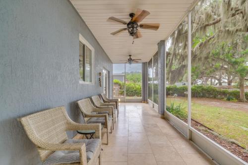 a row of chairs on a porch with a ceiling fan at Private Beach at Lakefront Summerfield Getaway! in Summerfield
