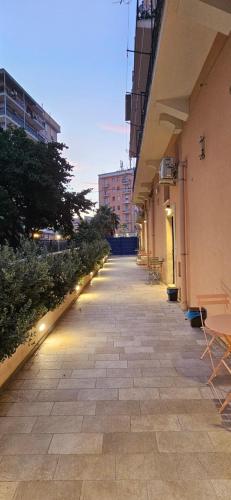 an empty sidewalk with lights on the side of a building at Eos - Elegants Apartments & Suites in Siracusa