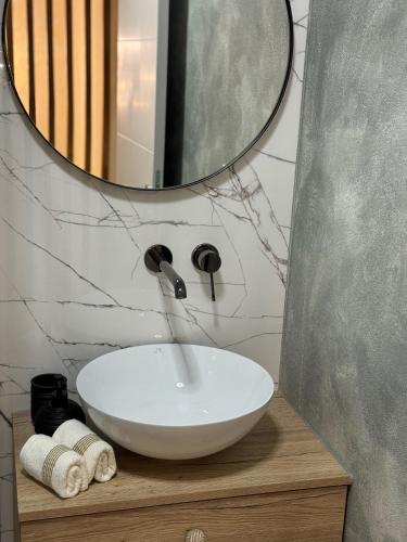 a bathroom with a white sink and a mirror at Aura Adriatica Olive - Luxury Apartment, private pool, sea view, parking in Lovran